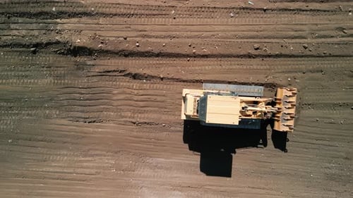 Bulldozer Moves Earth in Aerial Shot