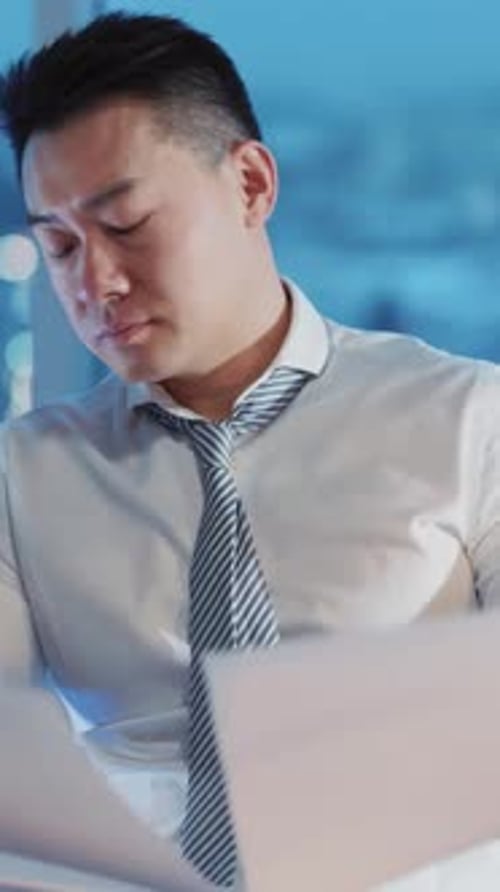 Dedicated and Focused Professional Analyzing Financial Documents in a Corporate Office Setting