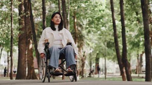 Young Woman Enjoying a Relaxing Day at the Park in Her Wheelchair