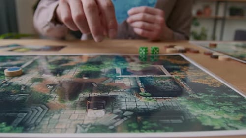Hands of Player Moving Token on Detailed Map during Tabletop Game