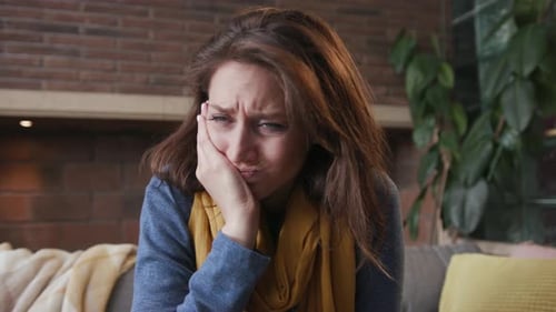 Woman Experiencing Pain and Discomfort in Living Room