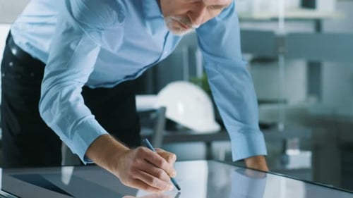 Senior Architectural Engineer Draws Building Concept on a Graphics Tablet Display Vertical Touchscr