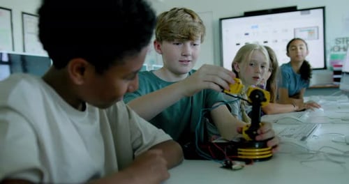 School Children in STEM Computer Classroom, Looking at Robot arm