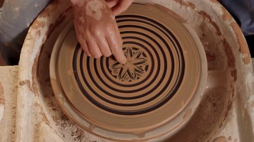The Hands of a Man Potter Draw Ornaments on a Wet Clay with Fingers An Artisan Uses a Rotating