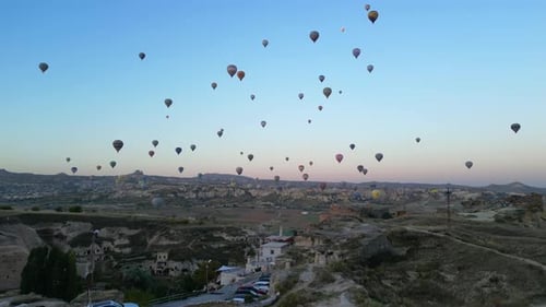 Hot Air Balloons Over Rural Landscape at Sunrise
