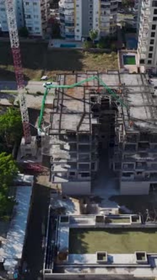 Vertical Video Workers Pour Concrete to Lay a Strong Foundation for a Multistory Residential
