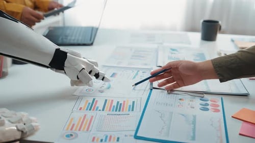 Robot and People Analyzing Charts and Business Data