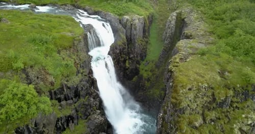 Aerial view of Large waterfall with green landscape in Iceland