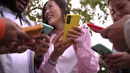 Group of Multiracial Student Friends Gathering in Circle Using Mobile Phones Together