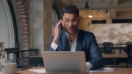 Business Man Working on Laptop at Desk Indoors