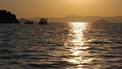 Boats Sailing on Water at Sunset