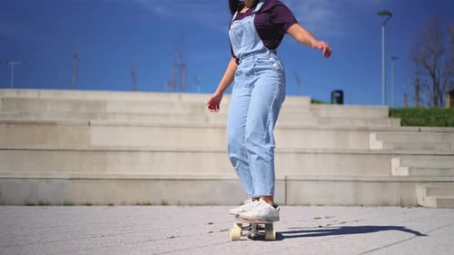 Woman Skateboarding in Urban Area on Sunny Day