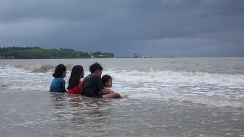 A group of children playing on the beach