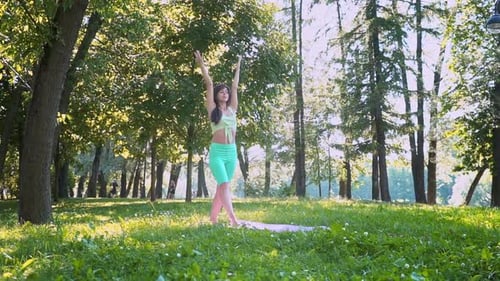 Beautiful Brunette Woman Sportswear Trains Yoga Asana Green Juicy Grass Purple Mat Barefoot Doing