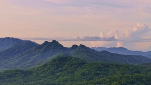 breathtaking nature scenery of greenery mountain range and orange sunrise sky.