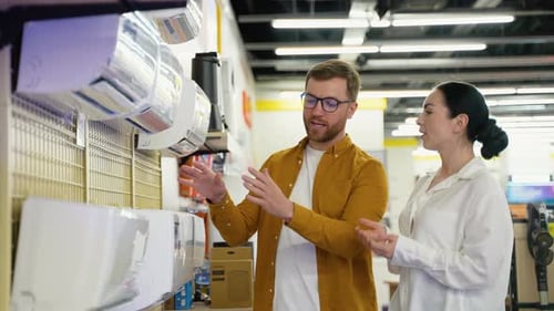 Couple Choosing Air Conditioner in Home Appliance Store for New Home
