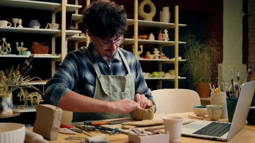 Man Crafting Pottery Bowl in Bright Creative Studio
