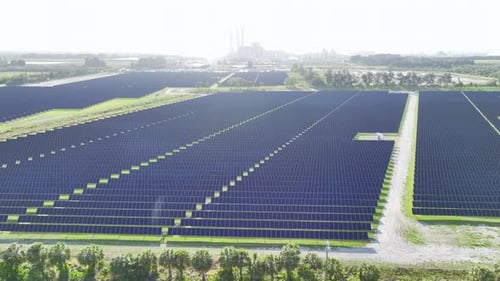 Aerial View of Big Sustainable Electric Power Plant with Many Rows of Solar Photovoltaic Panels for