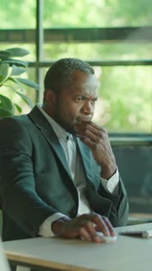 Successful Businessman Using Computer in Modern Office