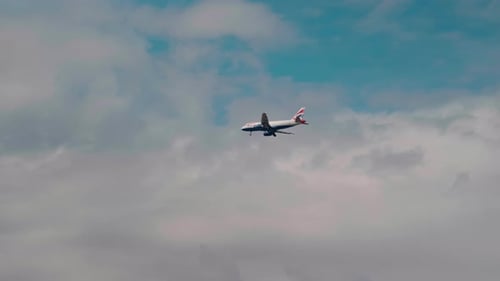 Commercial Airplane Flying Through Cloudy Sky