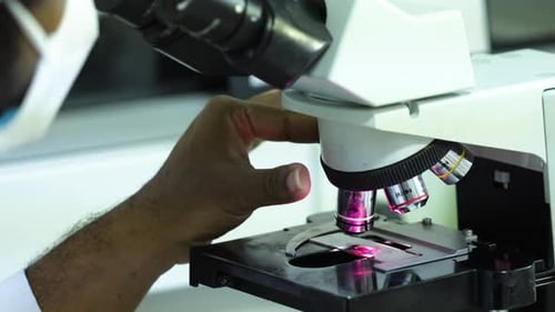 Medical Student Using A Microscope