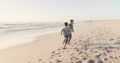 Playful, holiday and boys running, beach and happiness with sand, weekend fun and freedom with joy