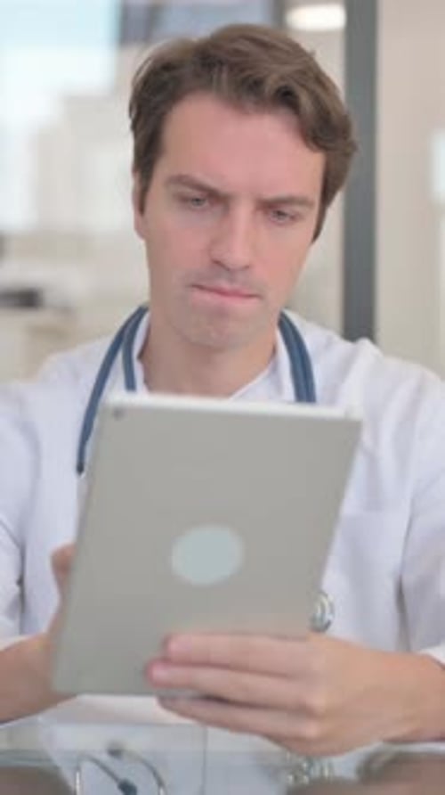 Doctor Using Tablet for Medical Data in Office