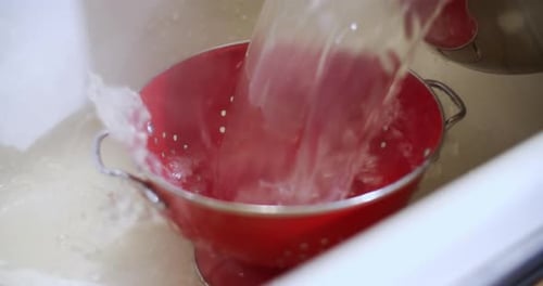 Pouring Cooked Spaghetti and Edamame into Colander