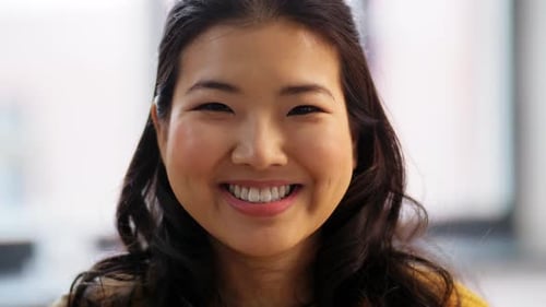 Smiling young woman portrait with wavy dark hair