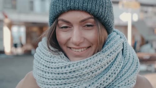 Woman Smiling with Hat and Scarf in City