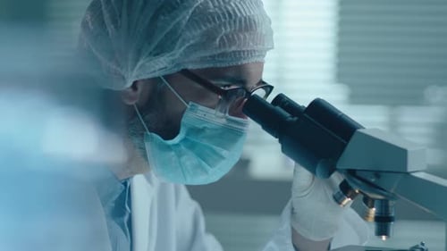 Scientist Using Microscope in a Modern Lab