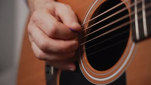 Man Playing Acoustic Guitar Closeup Guitar Deck and Musician's Hand Wooden