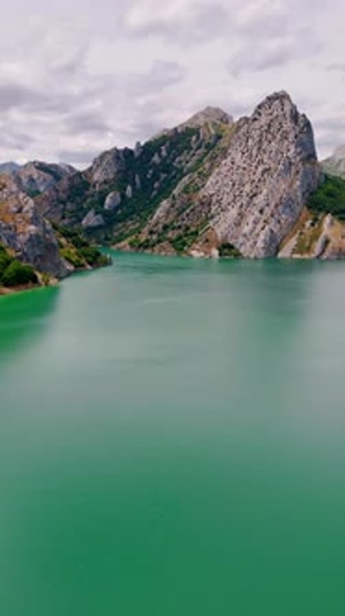 Turquoise Lake Surrounded by Towering Mountains
