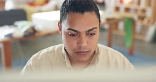 Young Adult Working on Computer Indoors