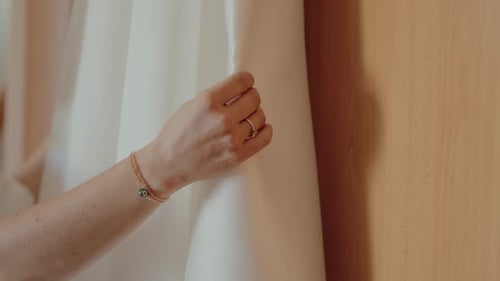Woman touches a white wedding dress
