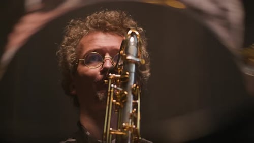 Concentrated Male Musician Enjoying Performing Jazz on Saxophone