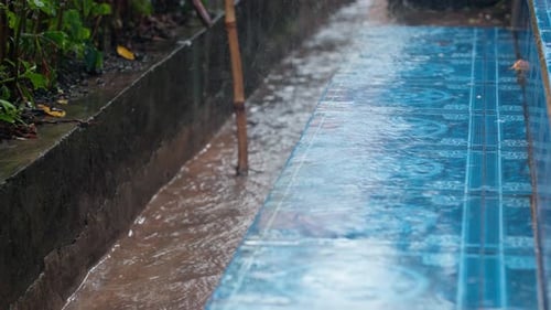 Heavy Rain Splashing on Tiled Patio and Flowing in Drain