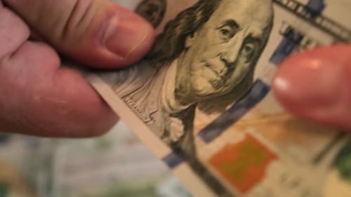 Hands Counting United States Hundred Dollar Bills