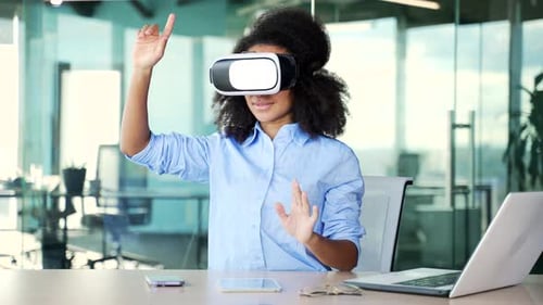 Young african american female employee works using VR glasses in virtual reality simulator while