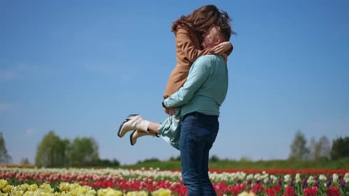 A Romantic Couple Celebrating Together in a Beautiful Flower Field Full of Blooms