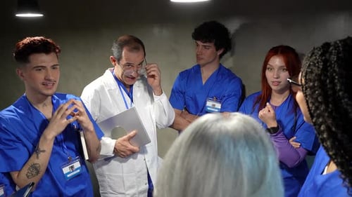 Professor doctor training medical students in hospital briefing