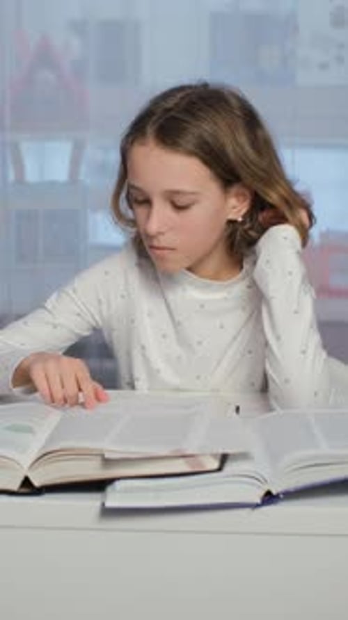 Child Studies and Reads Books at Home