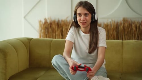 Young Woman Playing Video Game on Couch