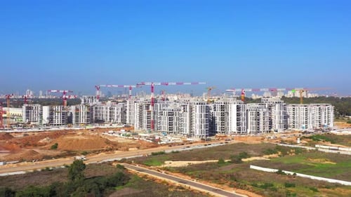 Residential Construction site with Cranes and building in progress, Aerial view.