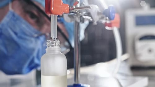 Scientist Fills Bottle with Liquid in Laboratory