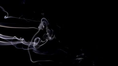 Wispy White Smoke Rising Against Black Background