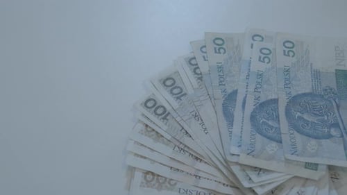 Panoraming stack of polish banknotes on white table