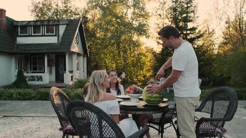 Family Enjoys Watermelon in Rural Setting
