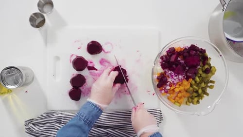 Flat Lay Step By Step Cutting Cookies Vegetables on a White Cutting Board for Vinaigrette Salad