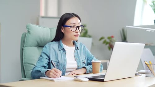 Focused Young Adult Working at Home Office